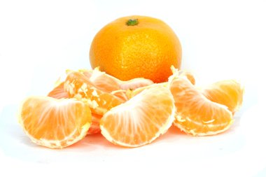 Slices of peeled orange on white background clipart