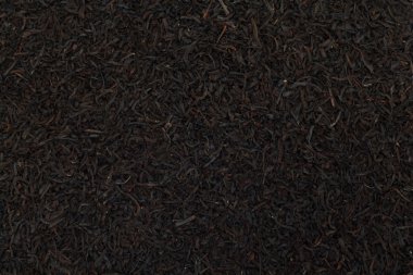 Black tea leaves background. Abstract food textures. clipart