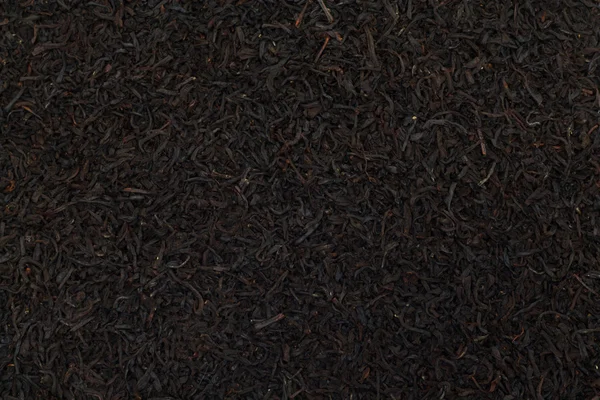El té negro deja el fondo. Texturas alimentarias abstractas . — Foto de Stock