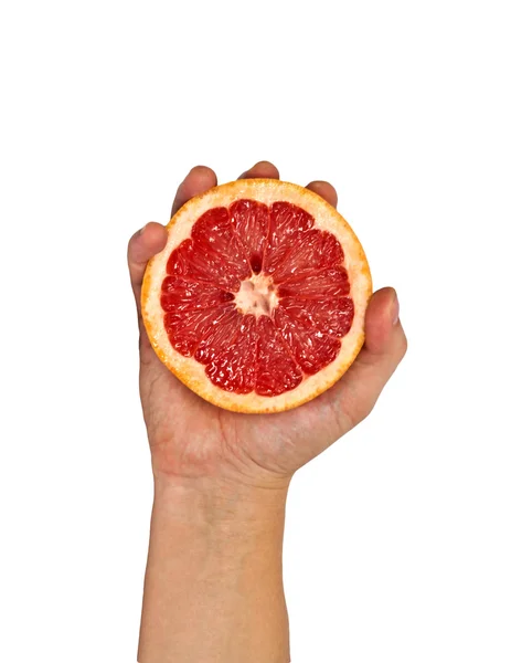 Hälfte der Grapefruit in weiblicher Hand. Isolation. — Stockfoto