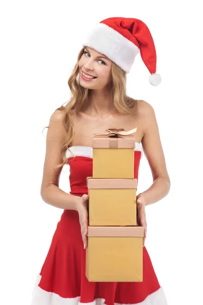 Christmas woman holding gifts wearing Santa costume — Stock Photo, Image