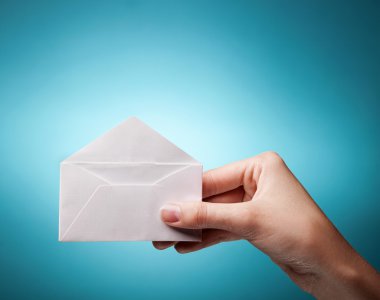 Woman's hand holding opened envelope against blue background clipart