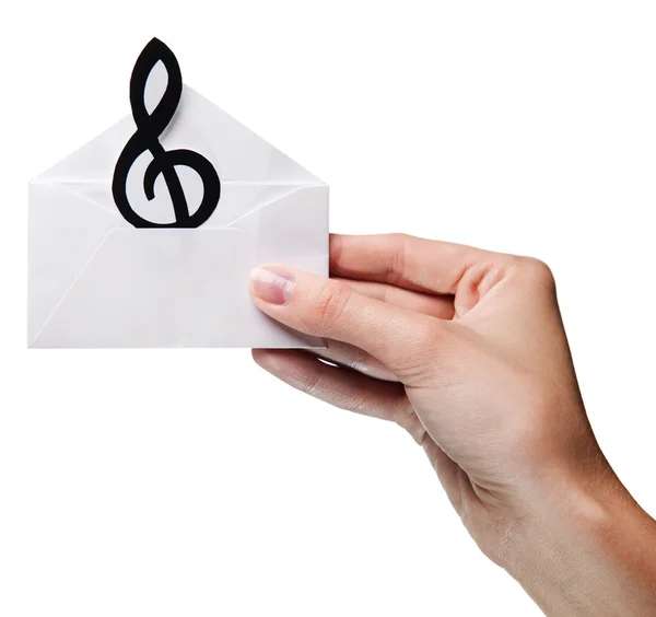 Woman's hand holding an envelope with a sign of the melody isola — Stock Photo, Image