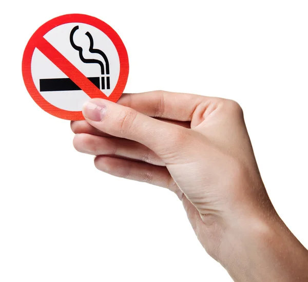 Woman's hand holding a symbol - no smoking. Isolated — Stock Photo, Image