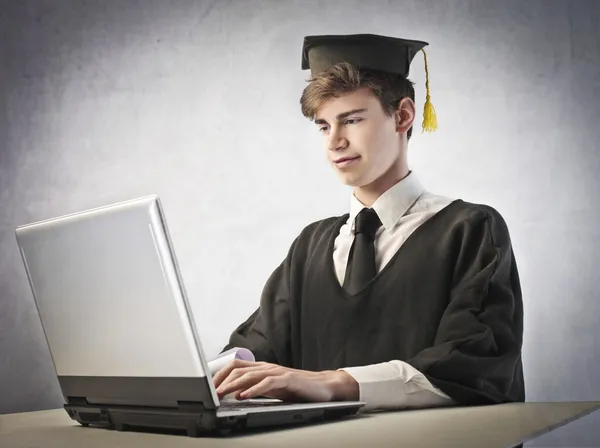 Grad student using a laptop — Stock Photo, Image