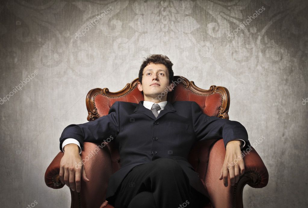 Young businessman relaxing on an armchair — Stock Photo © olly18 10515594