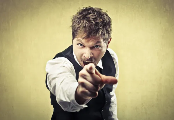 Angry man pointing his finger against somebody — Stock Photo, Image