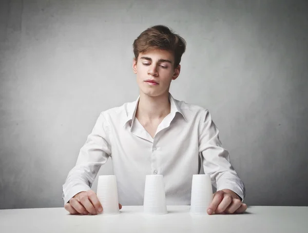 Young man playing a conjuring trick — Stock Photo, Image