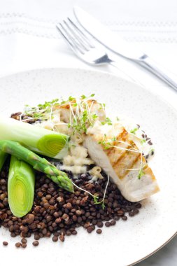 Butterfish with green lentils, leek and green asparagus clipart