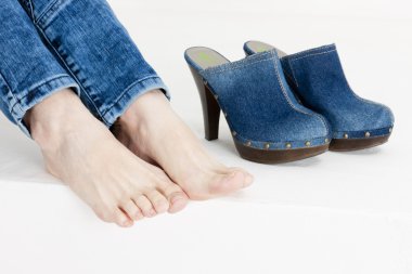 Detail of woman and denim clogs clipart