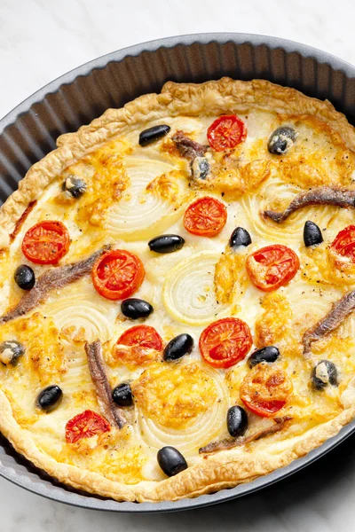 Cake with anchovies, cherry tomatoes and black olives — Stock Photo, Image