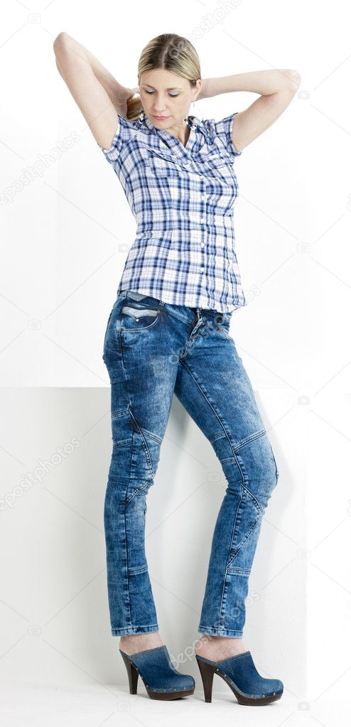 Standing woman wearing jeans and denim clogs