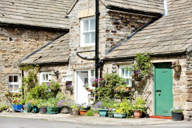 House with plants in Blanchland, Northumberland, England clipart