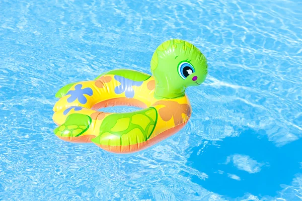 Child's green rubber ring in swimming pool — Stock Photo, Image