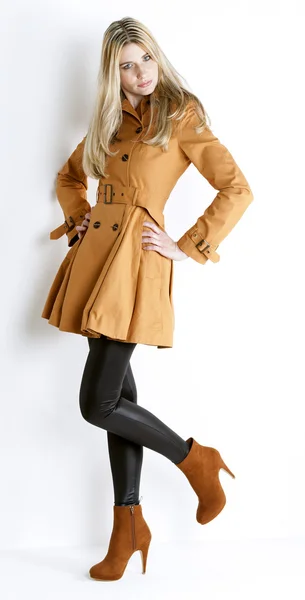 Standing woman wearing coat and fashionable brown shoes — Stock Photo, Image