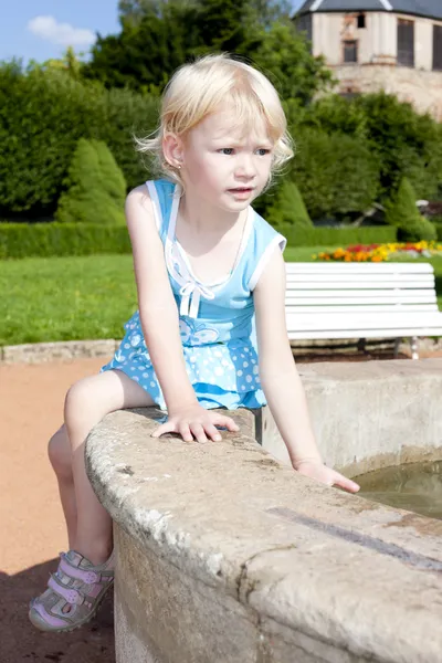 Little girl on fountain — Stock Photo, Image