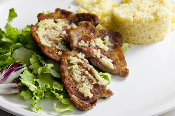 Grilled pork neck on garlic with couscous — Stock Photo, Image