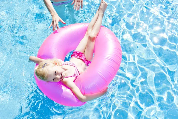 Holčička s gumovým kroužkem v bazénu — Stock fotografie