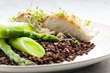 Butterfish with green lentils, leek and green asparagus clipart