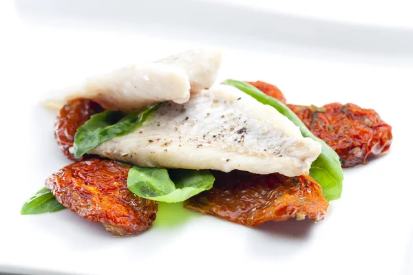 Cod with dried tomatoes and basil — Stock Photo, Image