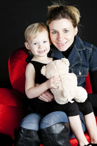 Mãe com sua filha segurando ursinho de pelúcia — Fotografia de Stock