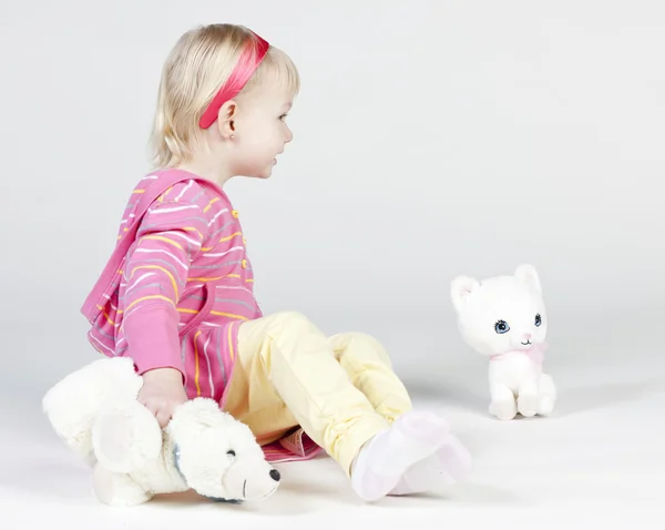 Little girl with toys — Stock Photo, Image