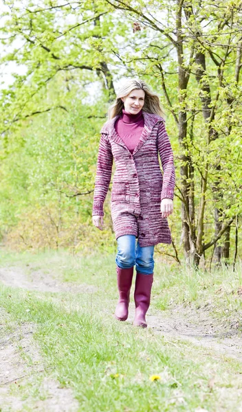 Woman wearing rubber boots in spring nature — Stock Photo, Image