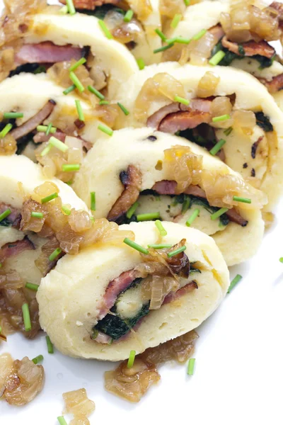 Roll from potato dough filled with spinach and bacon — Stock Photo, Image