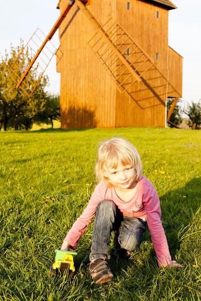 stock image Playing little girl at wooden windmill, Stary Poddvorov, Czech R