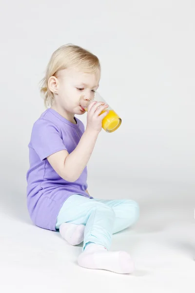 Niña bebiendo jugo de naranja —  Fotos de Stock