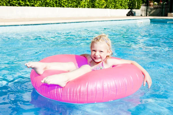 Маленька дівчинка з гумовим кільцем у басейні — стокове фото