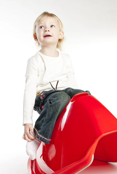 Little girl sitting on swing — Stock Photo, Image