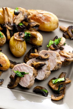 Pork tenderloin baked on mushrooms clipart