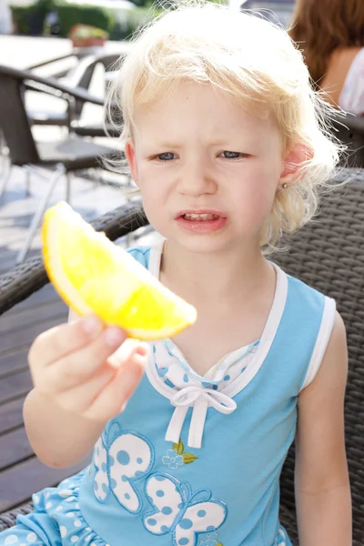 Portrait of little girl with an orange — Stock Photo, Image