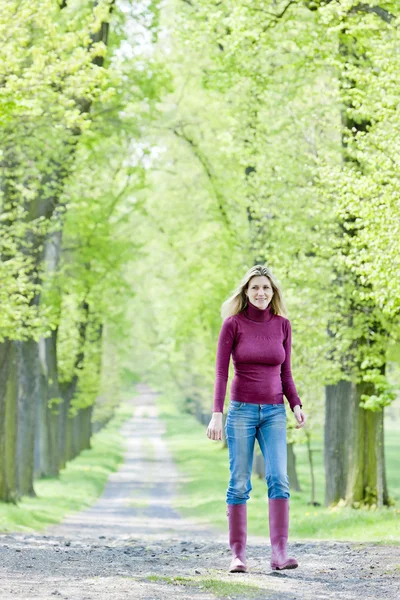 여자 착용 고무 부츠 봄 골목 산책 — 스톡 사진