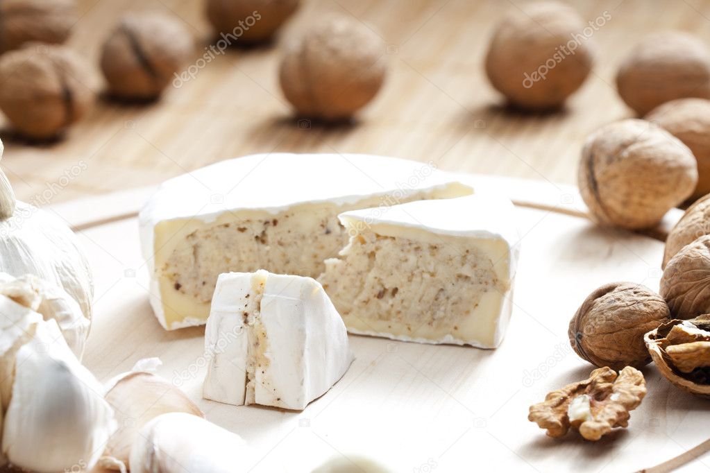 Cheese brie filled with cheese mixture of chopped walnuts and ga