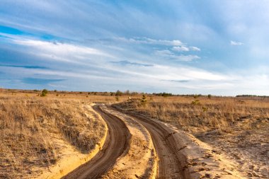 Dirt road in steppe clipart