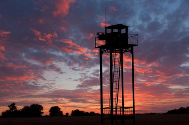 Watch tower on sunset sky clipart