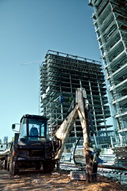 Construction site - excavator and scaffolds clipart