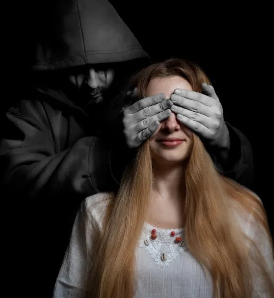 Death concept: woman surprised by evil sinister man — Stock Photo, Image