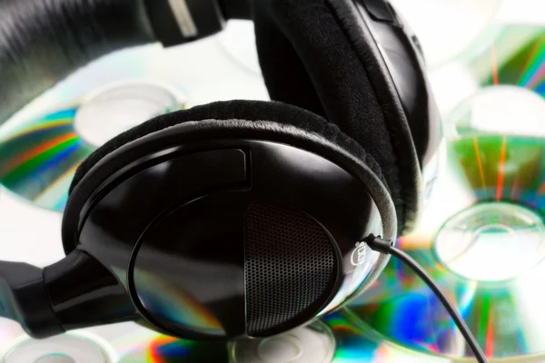 Headphones on top of audio cds — Stock Photo, Image