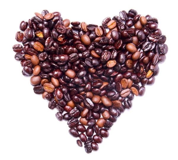 Kształt serca, założony przez kilka ziaren kawy — Zdjęcie stockowe