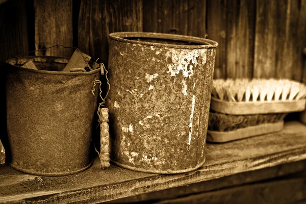Vintage objects - two rusty greasy cans on wooden shelf — Stock Photo, Image
