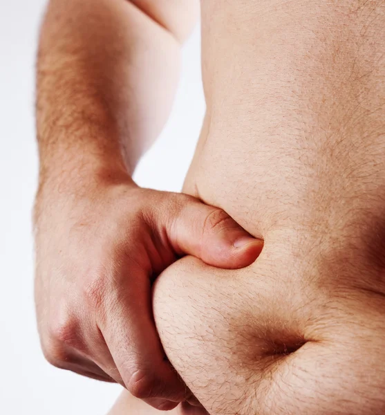 Homem segurando sua barriga gorda isolado em branco — Fotografia de Stock