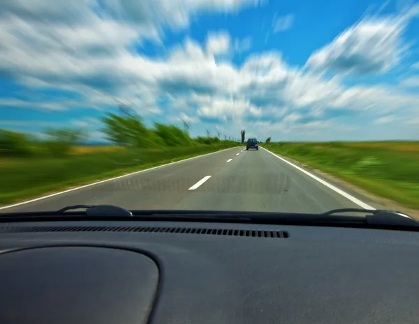 Fast car on road viewed from the interior — Stock Photo, Image