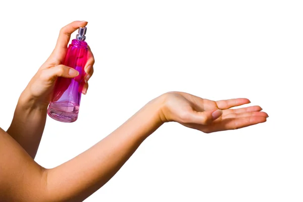 Női kéz és a parfümös üveg — Stock Fotó