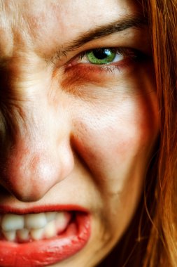 Face of angry woman with evil scary eyes clipart