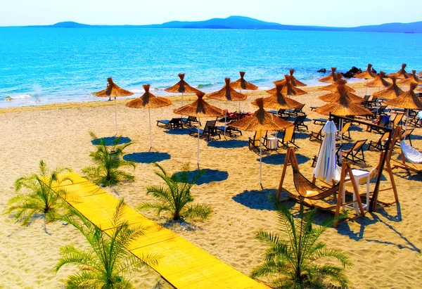 stock image Straw umbrellas on beautiful sunny beach