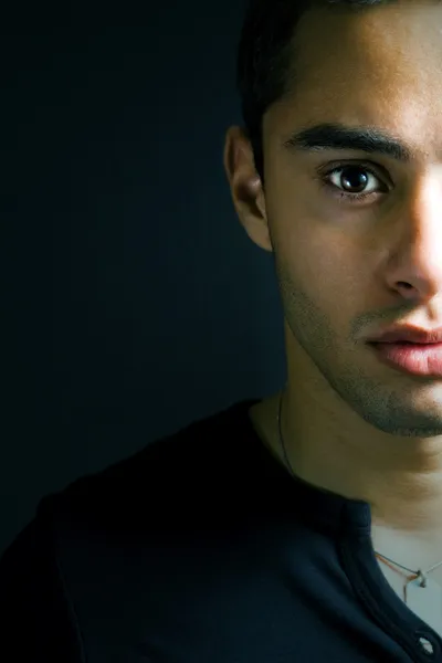 Half face portrait of one serious young man — Stock Photo, Image