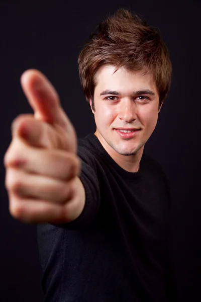 Handsome man pointing forward with his finger — Stock Photo, Image